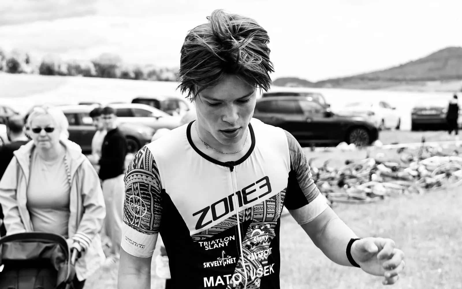 Oliver in his tri suit at the race site. Black and white.